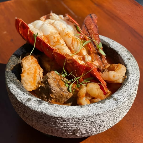 Hidalgo’s Cocina & Cócteles' Molcajete with lobster tail, shrimp, and steak in a stone bowl.